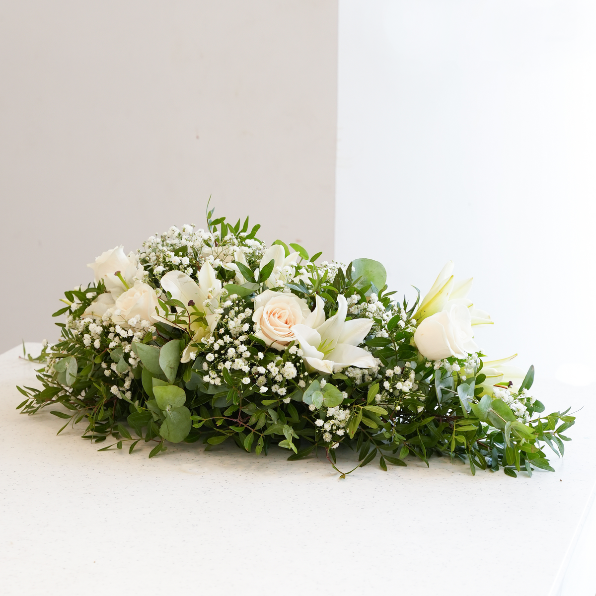 
              White Roses and White Lily Funeral Spray